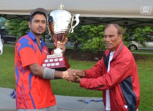 Bhan Deonarine presents the trophy to Quebec